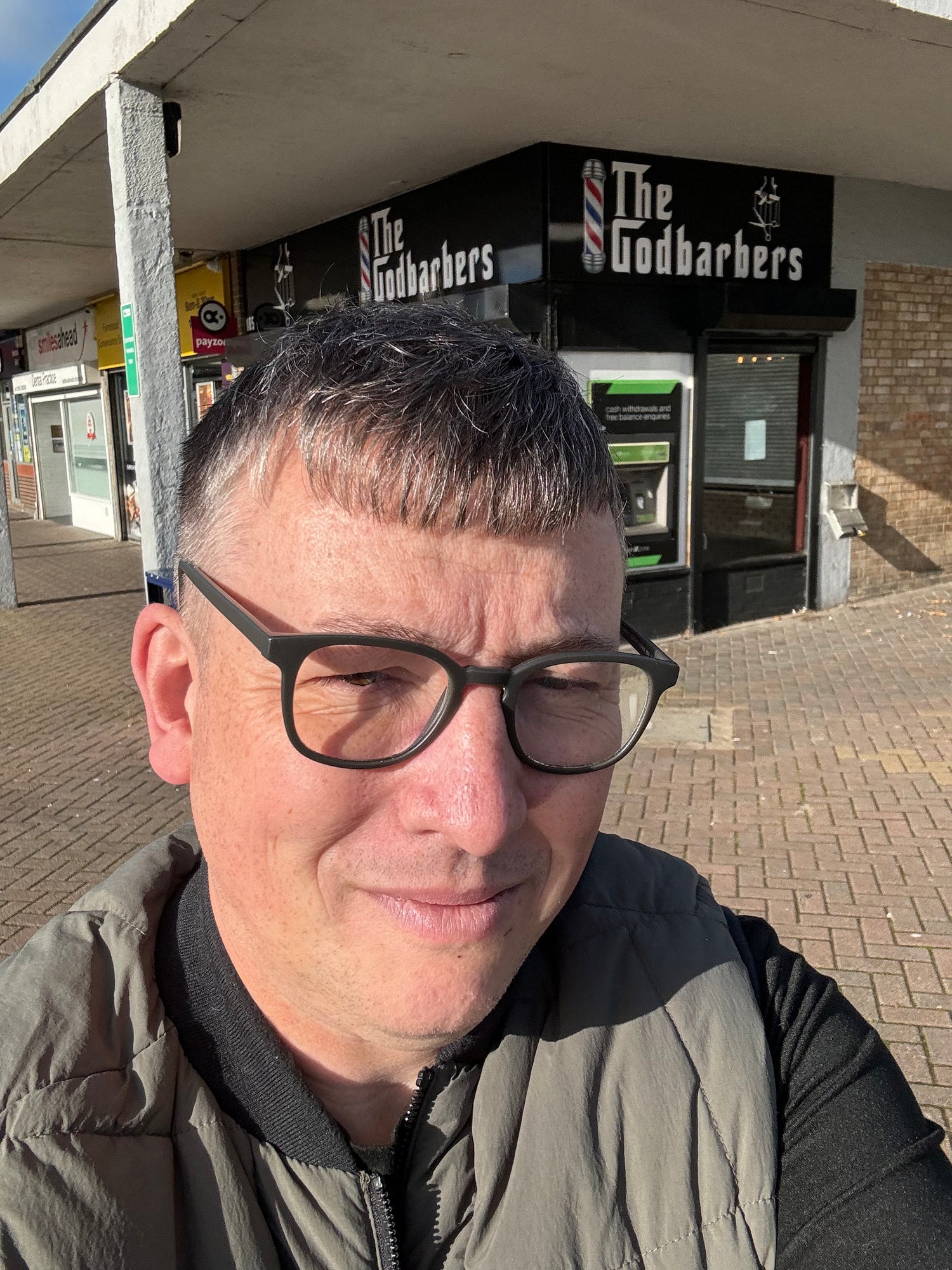 photo of Simon Farrant outside a barber's shop 